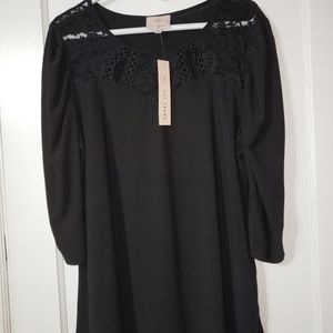 Cute black top with chest accent!